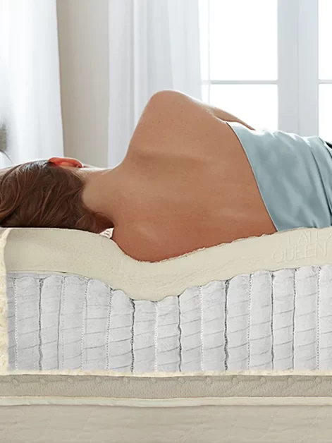 a woman lies on a comfortable Hybrid Mattress