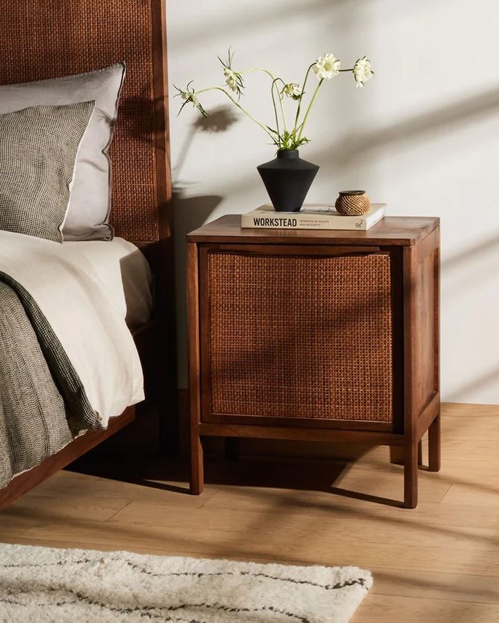 A bedroom in brown tones and minimalist decor with a bedside table